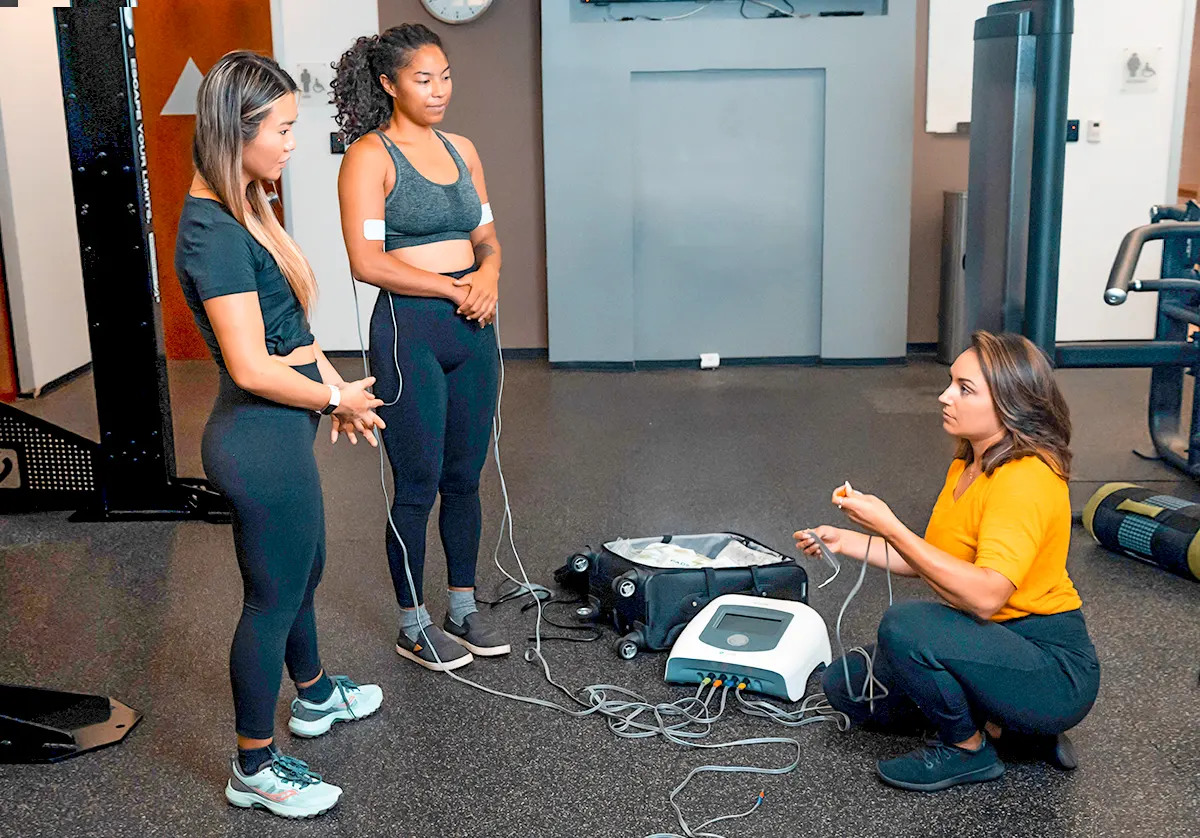 Two woman get scanned with Neufit Neubie device in San Diego with Dr. Rockie