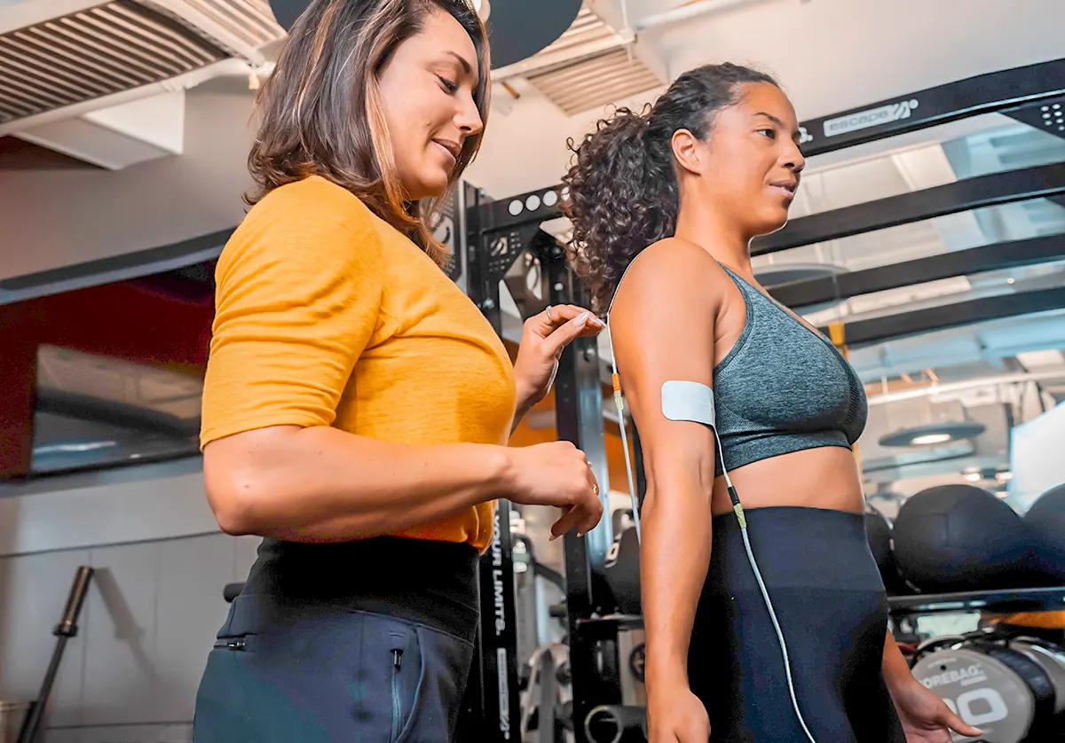 Dr. Rockie attaches Neube electrode patch to physical therapy client